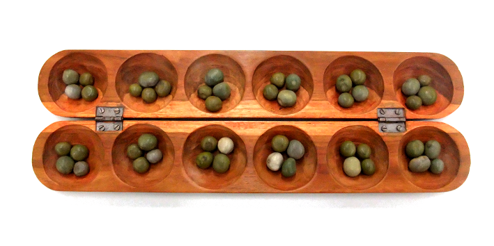 An oware board with seeds